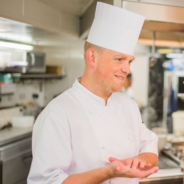 chef spencer westcott in the kitchen wearing uniform