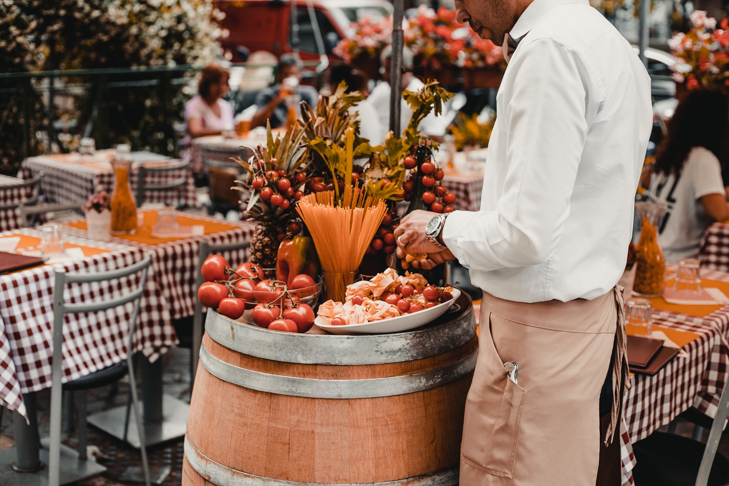 waiter in italy arranging antipasti platter in traditional restaurant