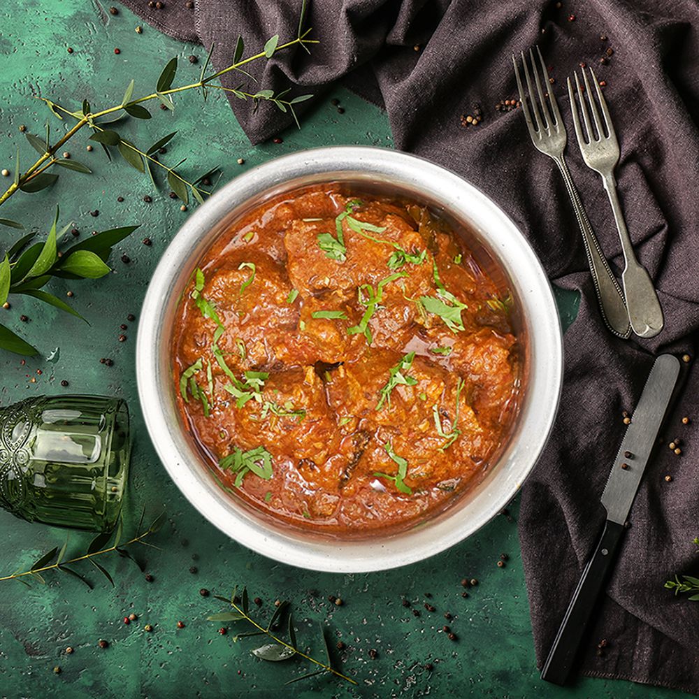 Indian lamb curry from above on a green tablecloth