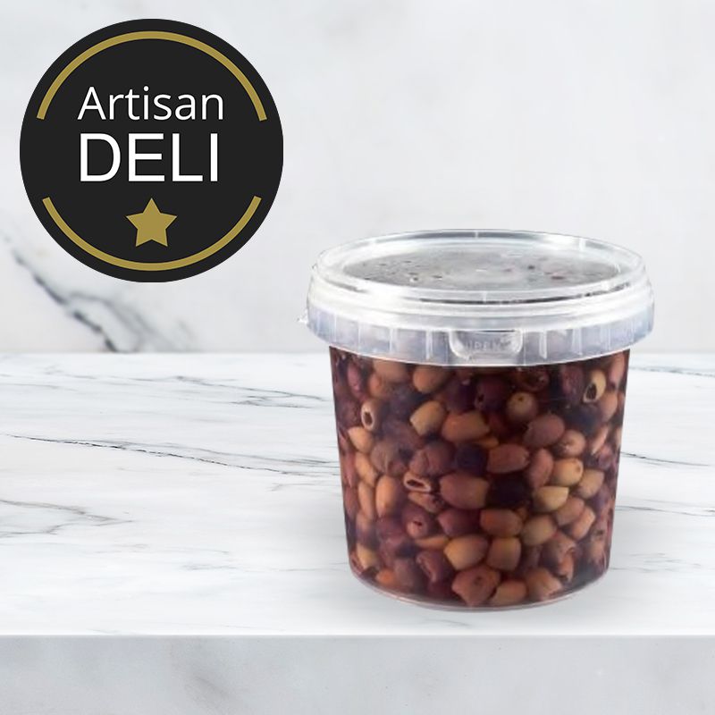 tub of italian black olives against a marble background