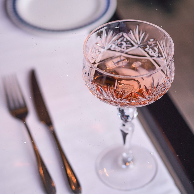 glass of french rose wine on a white tablecloth