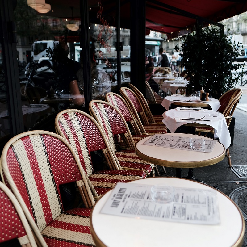 french cafe in paris red and white chairs