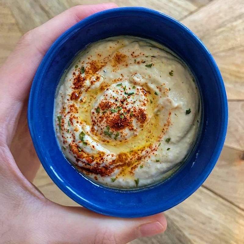 vegan hummus in a blue dish with spices