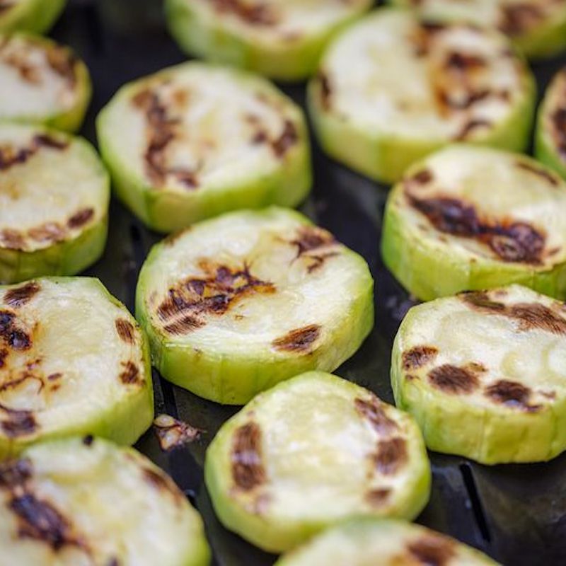 rows of grilled vegetables in a pan for vegan paella