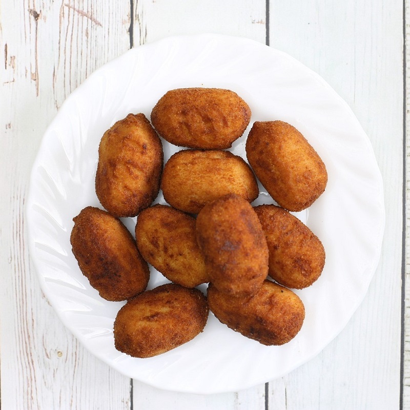 spanish ham croquetas on a white wooden table