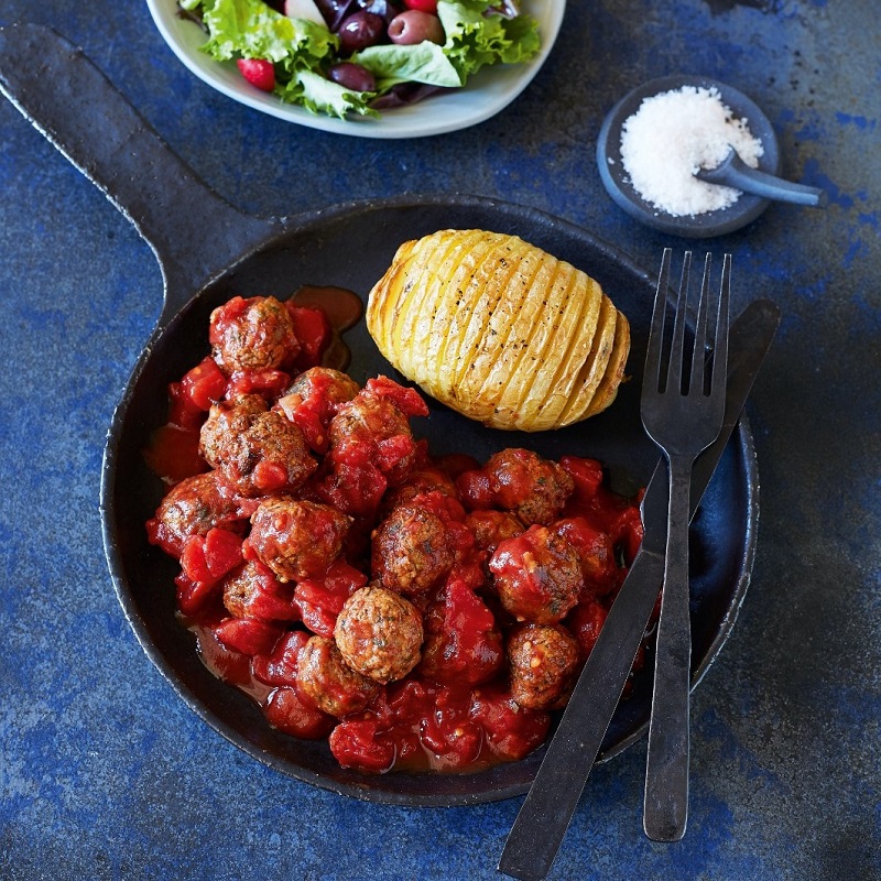 spanish food for kids meatballs in a tomato sauce on a blue table