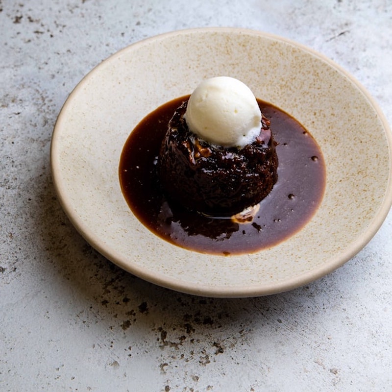 sticky toffee pudding topped with vanilla icecream