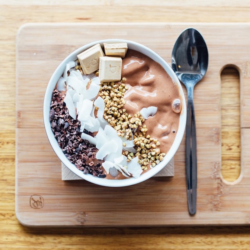 chocolate smoothie bowl with coconut, granola and white chocolate chunks