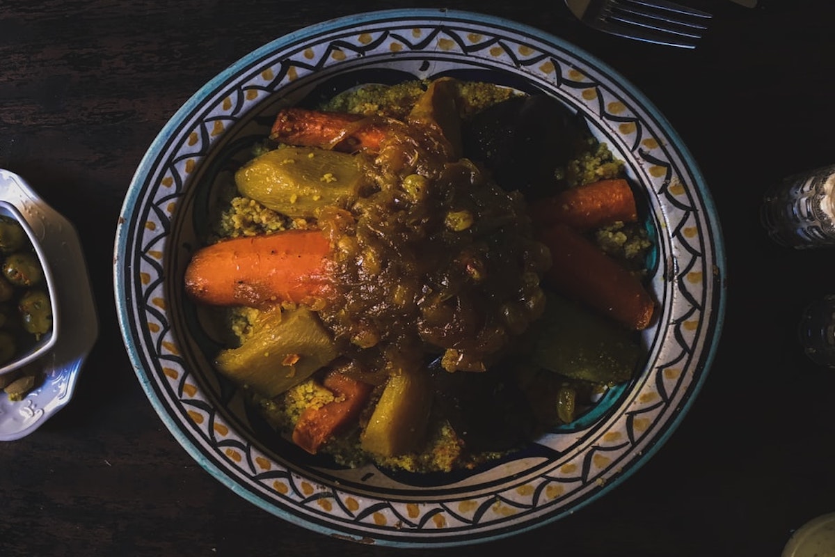 African stew with carrots and potatoes in a blue bowl