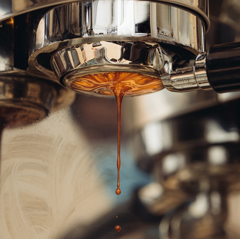 coffee dripping from a metal coffee machine